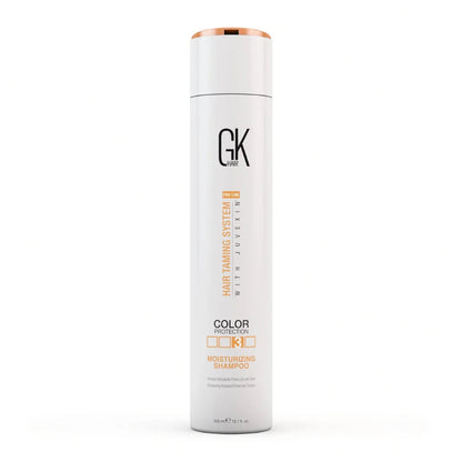 A tall white cylindrical bottle of GK Paris Juvexim Hair Taming System 4 Color Protection Moisturizing Shampoo, featuring a metallic rose gold cap and orange and black text on the front, set against a plain white background.