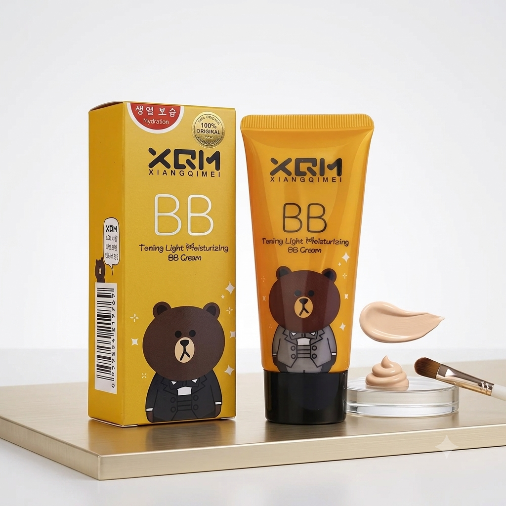 XRM Xiangqimei BB Cream in a yellow squeeze tube and matching box, featuring a cartoon bear illustration, displayed on a gold tray with a dollop of cream and a makeup brush against a white background.