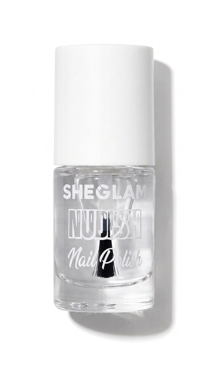 SheGlam Nudist Nail Polish in a clear glass bottle with a white cap, shown on a white background with a soft shadow.