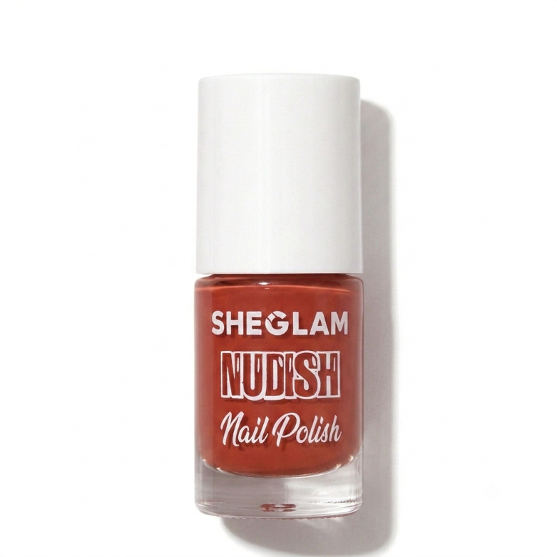 A bottle of SHEGLAM Nudish Nail Polish in a warm terracotta rust shade, featuring a white cap and clear glass bottle, set against a plain white background with a soft shadow.