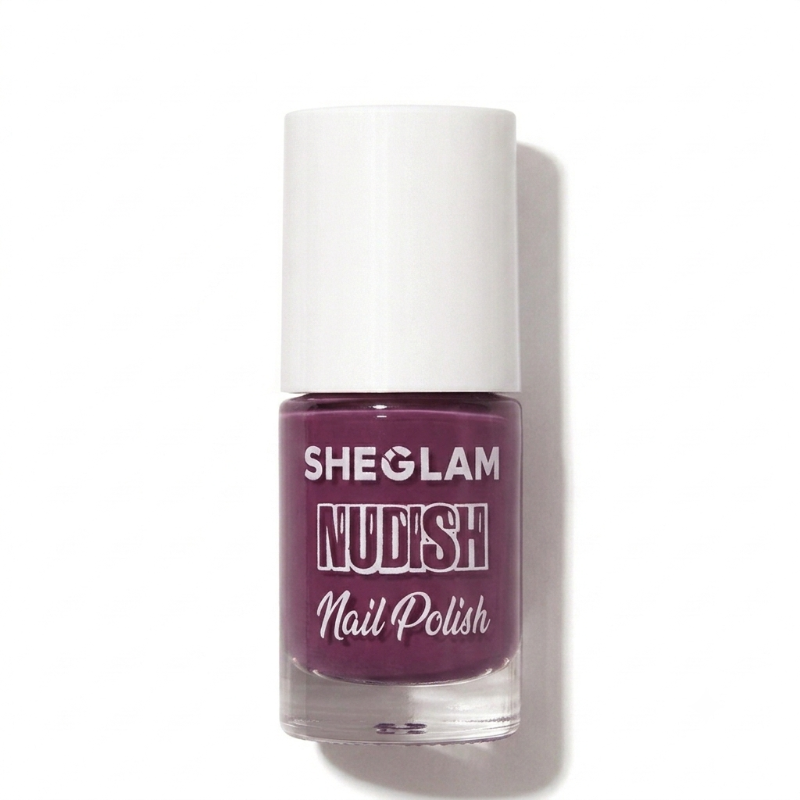 A bottle of SHEGLAM Nudish Nail Polish in a deep plum purple shade, featuring a white cap and clear glass bottle, set against a plain white background with a soft shadow.