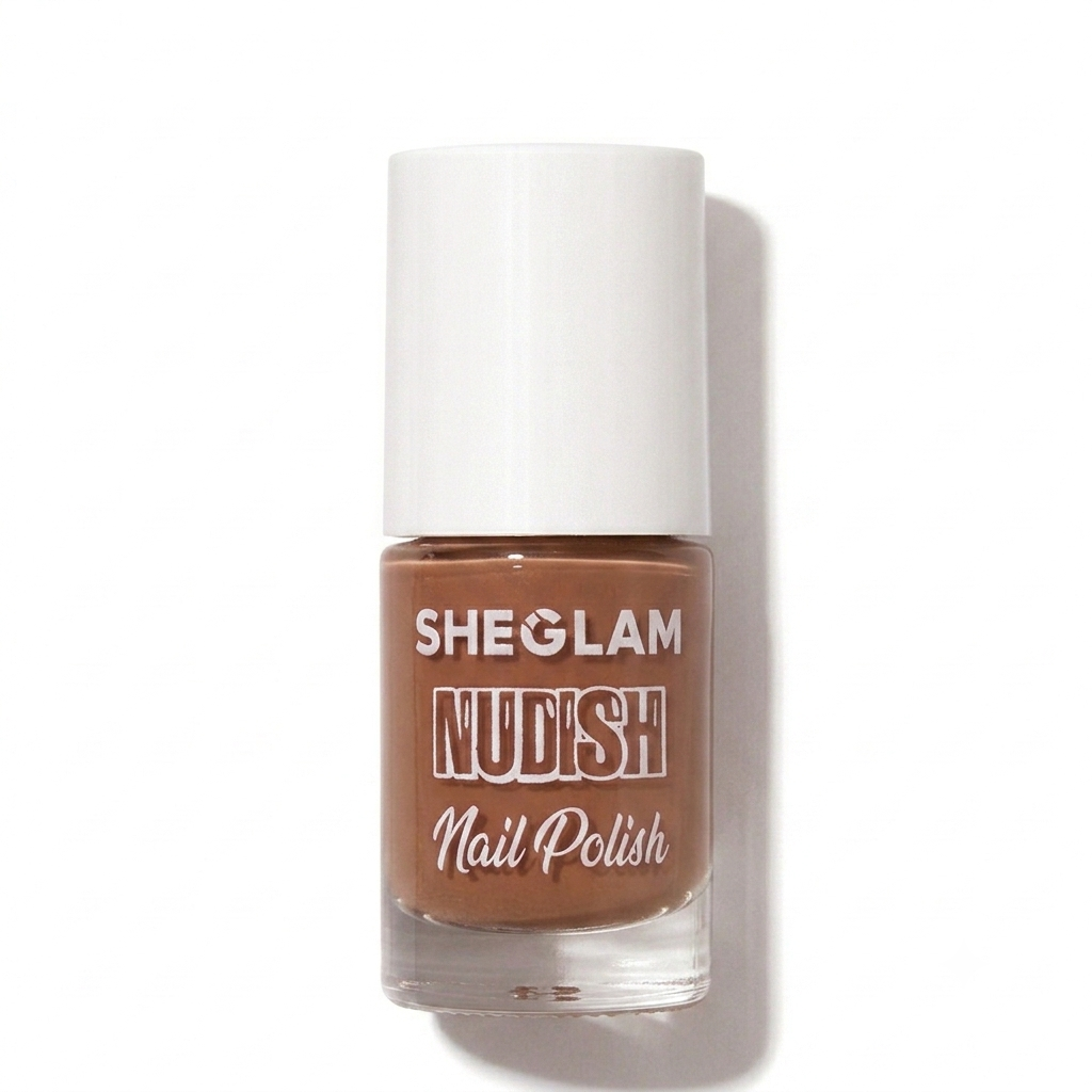 A bottle of SHEGLAM Nudish Nail Polish in a dusty mauve-purple shade, featuring a white cap and clear glass bottle, set against a plain white background with a soft shadow.